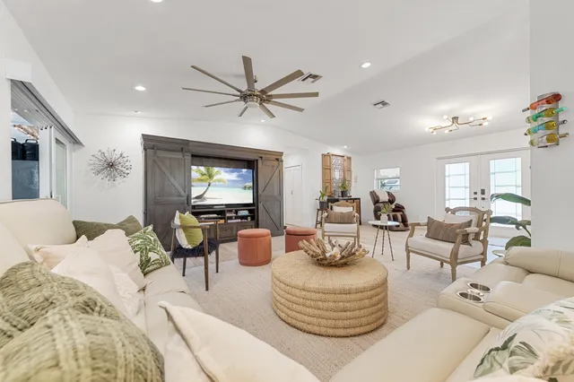 a living room with furniture and a chandelier