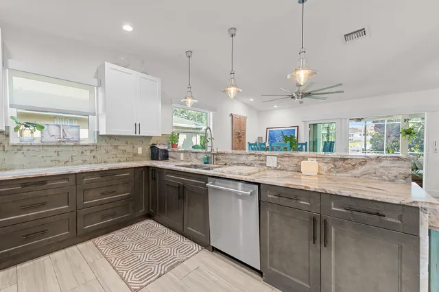 a kitchen with a sink and chandelier