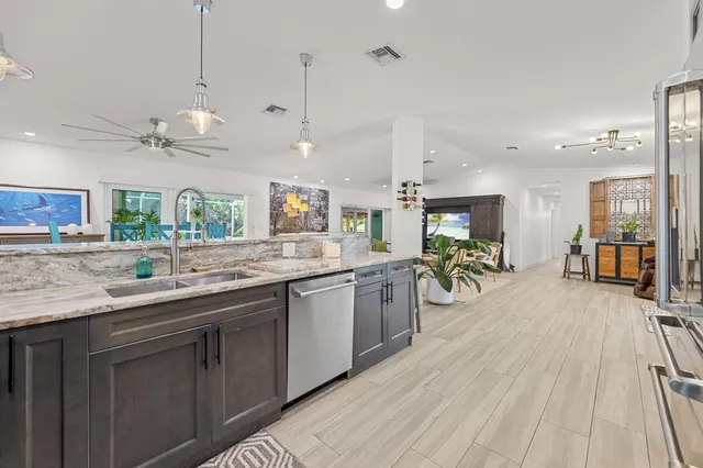 a kitchen with lots of counter top space sink stove and wooden floor