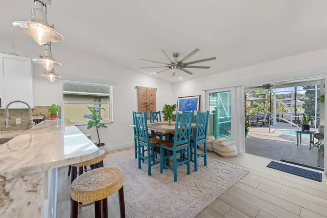 a view of a dining room with furniture and chandelier