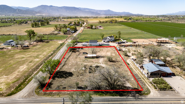 1211 West Midvalley Road Cedar City, UT 84721 - Photo 2 of 14 Expansive vacant lot featuring an irregular shape and mature trees, bordered by a paved road