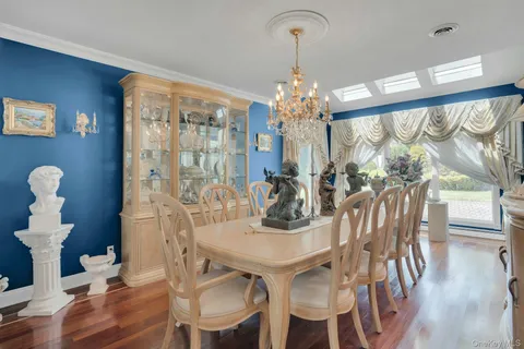 a view of a dining room with furniture and chandelier