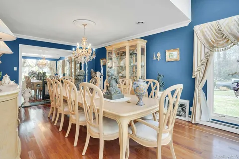 a living room with furniture a fireplace and a chandelier