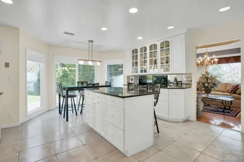 a kitchen with granite countertop counter space dining table and a sink