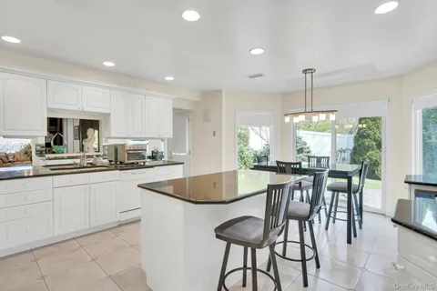 a large kitchen with a table and chairs