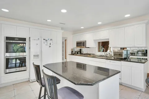 a view of a hallway with a table and chairs
