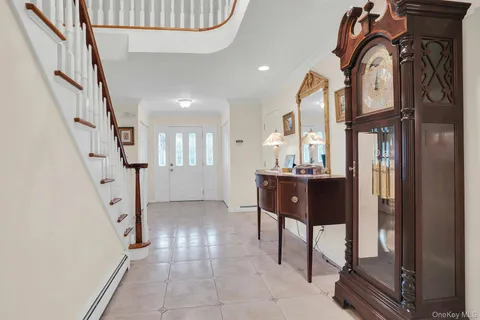 a view of staircase with lots of frames on wall and stairs