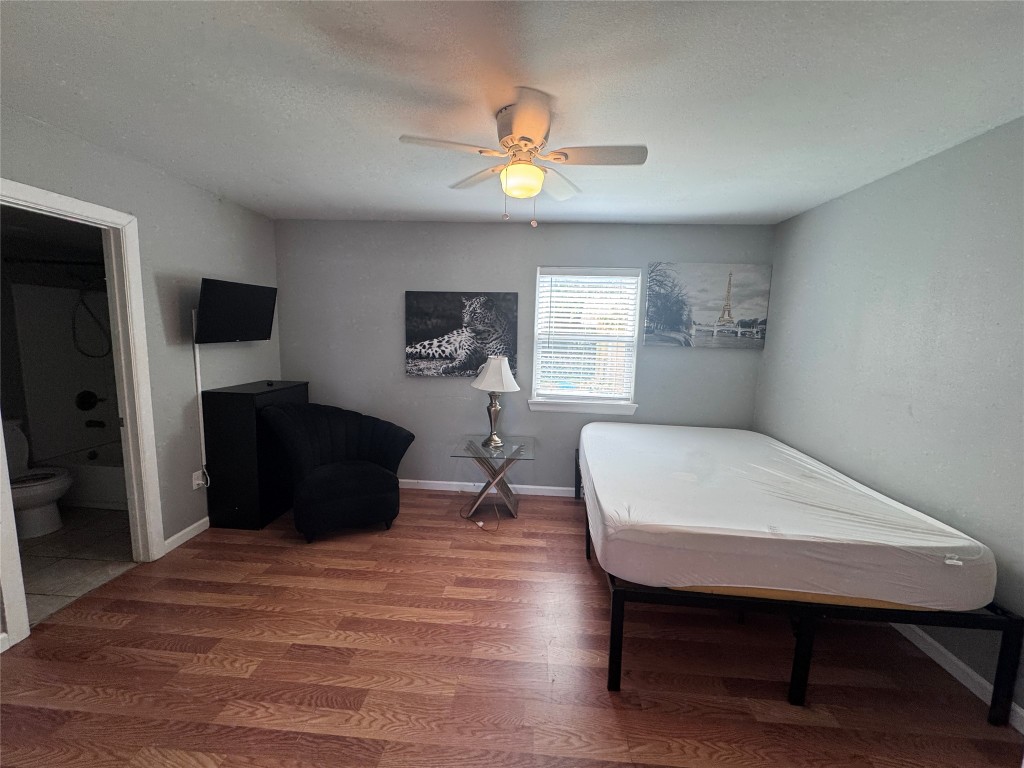 1402 North 2nd Street, Unit 4 Killeen, TX 76541 - Photo 12 of 13 a bedroom with a bed and a chandelier