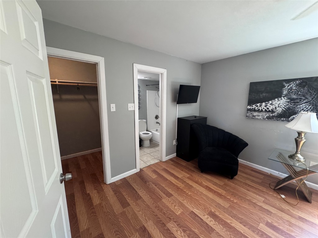 1402 North 2nd Street, Unit 4 Killeen, TX 76541 - Photo 6 of 13 a living room with a bed furniture and a window