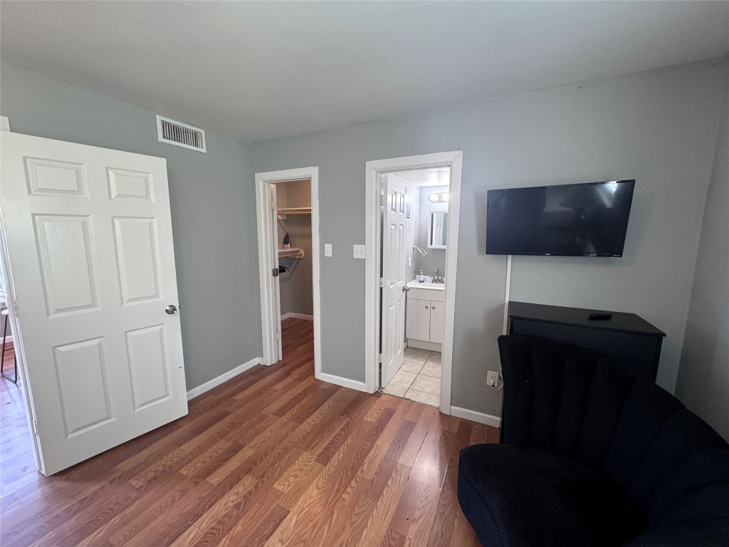 1402 North 2nd Street, Unit 4 Killeen, TX 76541 - Photo 8 of 13 a view of a livingroom with wooden floor and a flat screen tv