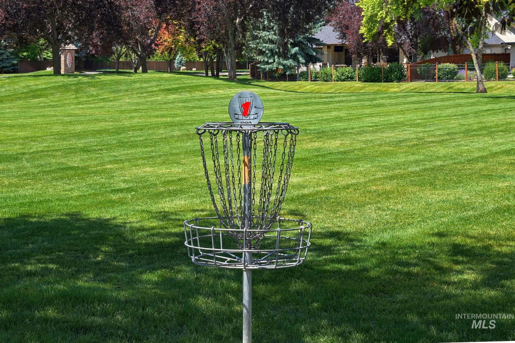2172 West Cedar Grove Street Meridian, ID 83646 - Photo 45 of 49 Expansive grassy area featuring a disc golf basket, mature trees, and a distant building