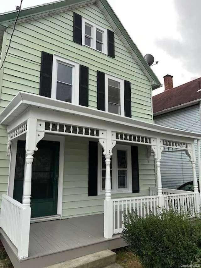 a front view of a house with a porch