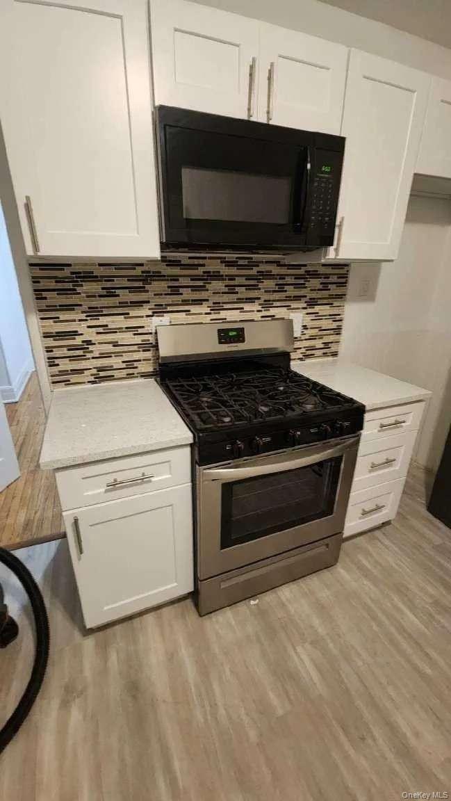 3 Allen Place Poughkeepsie, NY 12601 - Photo 4 of 6 a kitchen with a stove and a microwave