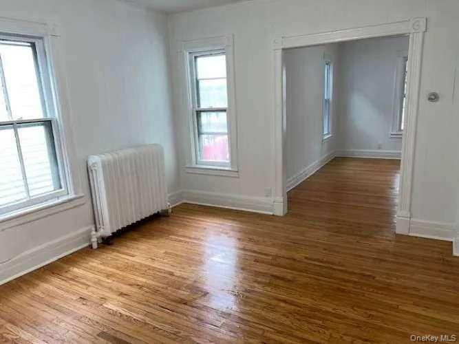 3 Allen Place Poughkeepsie, NY 12601 - Photo 5 of 6 an empty room with wooden floor and windows
