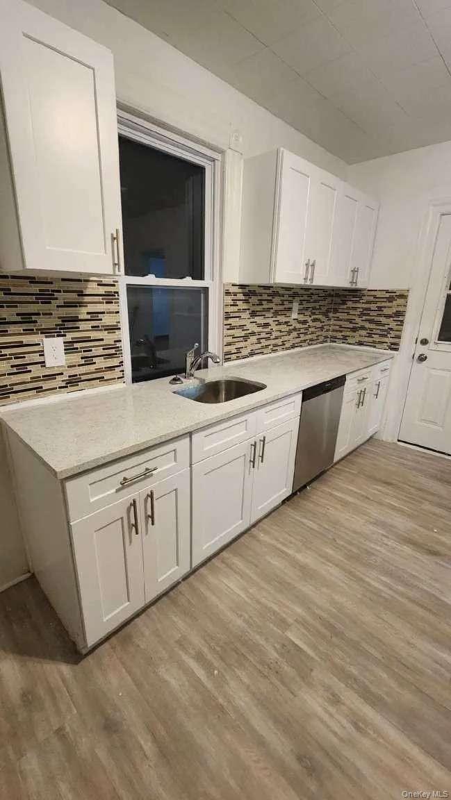 3 Allen Place Poughkeepsie, NY 12601 - Photo 6 of 6 a kitchen with granite countertop white cabinets and white appliances