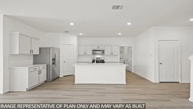 a view of kitchen with stainless steel appliances kitchen island