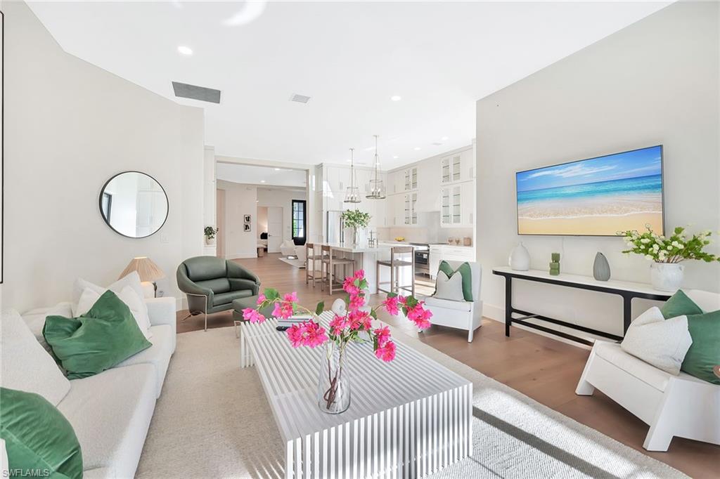 981 Tierra Lago Way Naples, FL 34119 - Photo 20 of 49 a living room with furniture and a chandelier