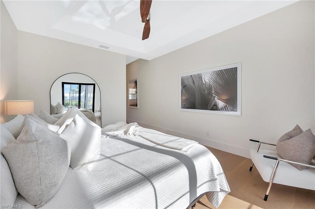 981 Tierra Lago Way Naples, FL 34119 - Photo 24 of 49 a bedroom with a bed and a painting on the wall