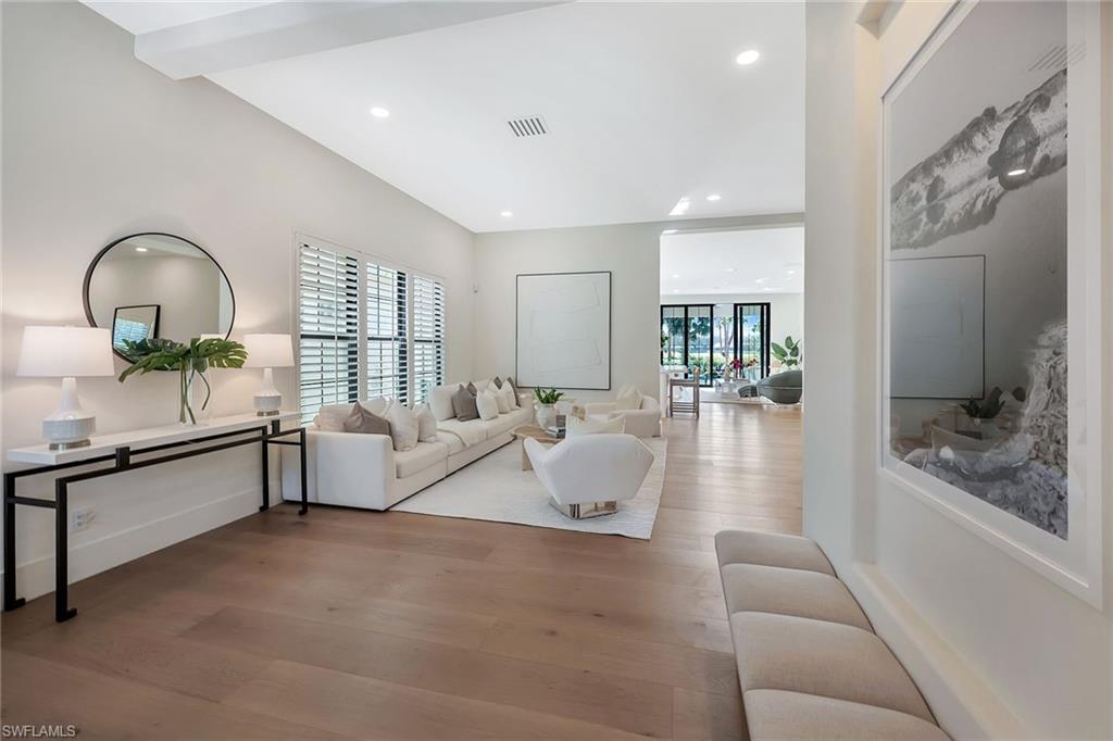 981 Tierra Lago Way Naples, FL 34119 - Photo 3 of 49 a living room with furniture and a large window