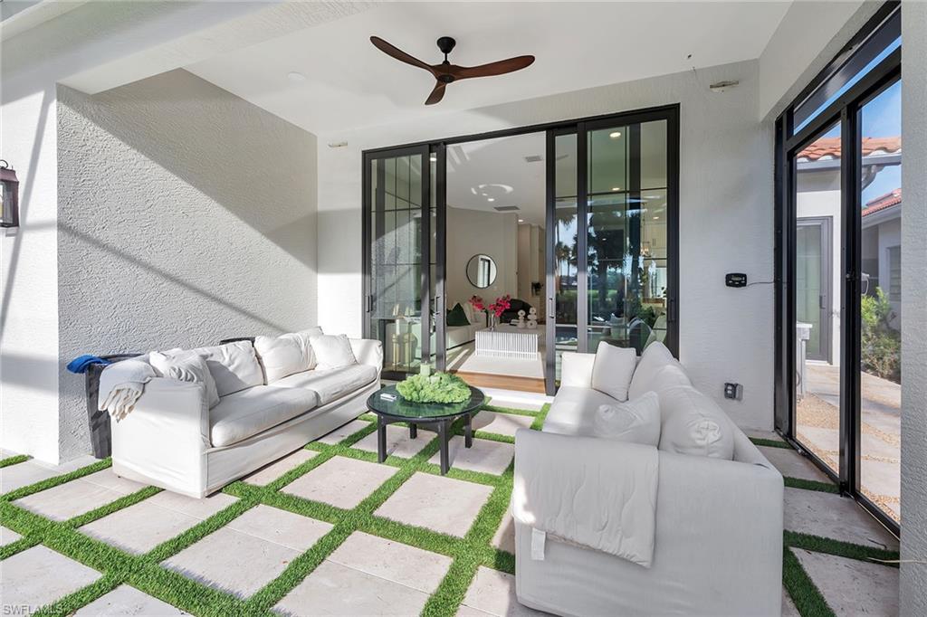 981 Tierra Lago Way Naples, FL 34119 - Photo 40 of 49 a living room with furniture and a large window