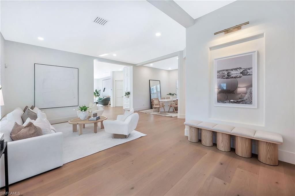 981 Tierra Lago Way Naples, FL 34119 - Photo 4 of 49 a living room with furniture and a wooden floor