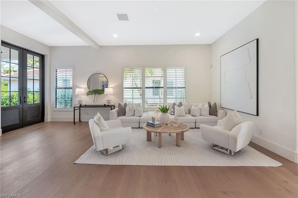 981 Tierra Lago Way Naples, FL 34119 - Photo 7 of 49 a living room with furniture and a window