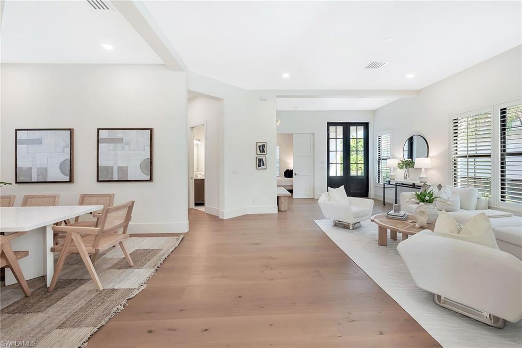 981 Tierra Lago Way Naples, FL 34119 - Photo 8 of 49 a living room with furniture and wooden floor