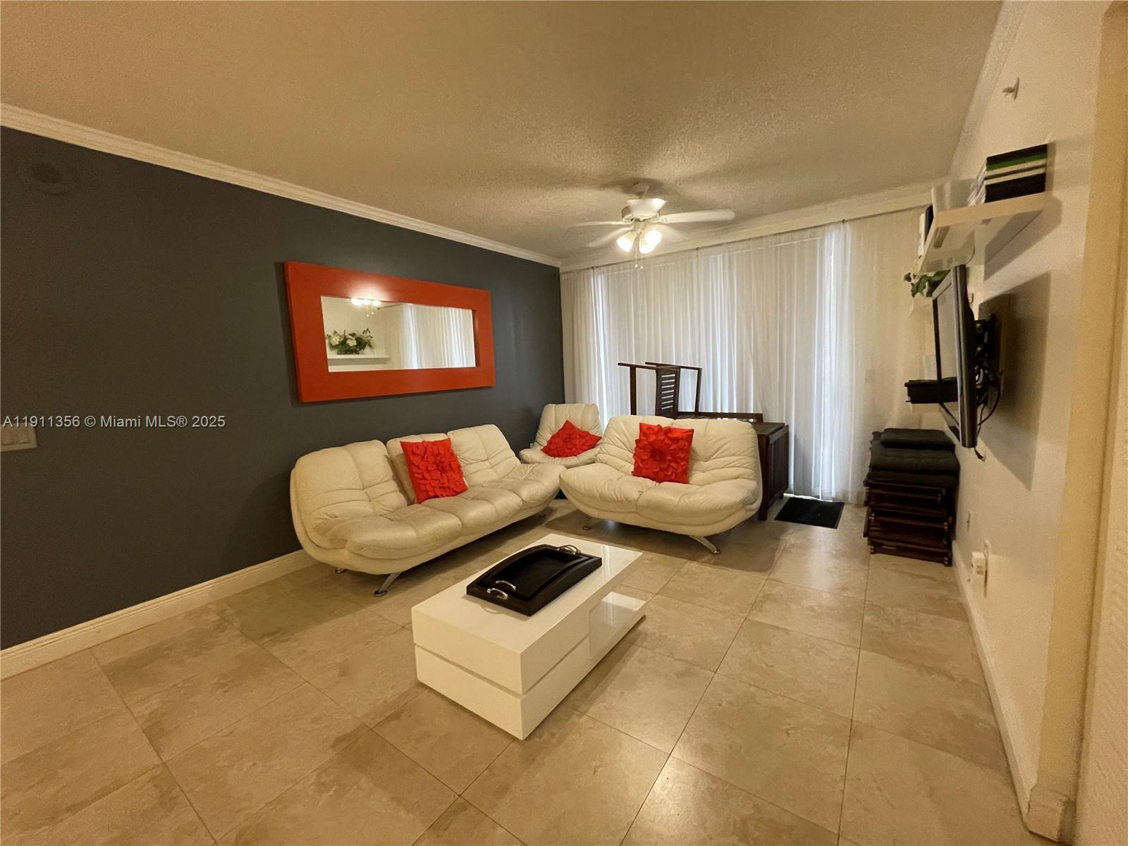 17100 North Bay Road, Unit 1118 Sunny Isles Beach, FL 33160 - Photo 24 of 34 a living room with furniture and a flat screen tv