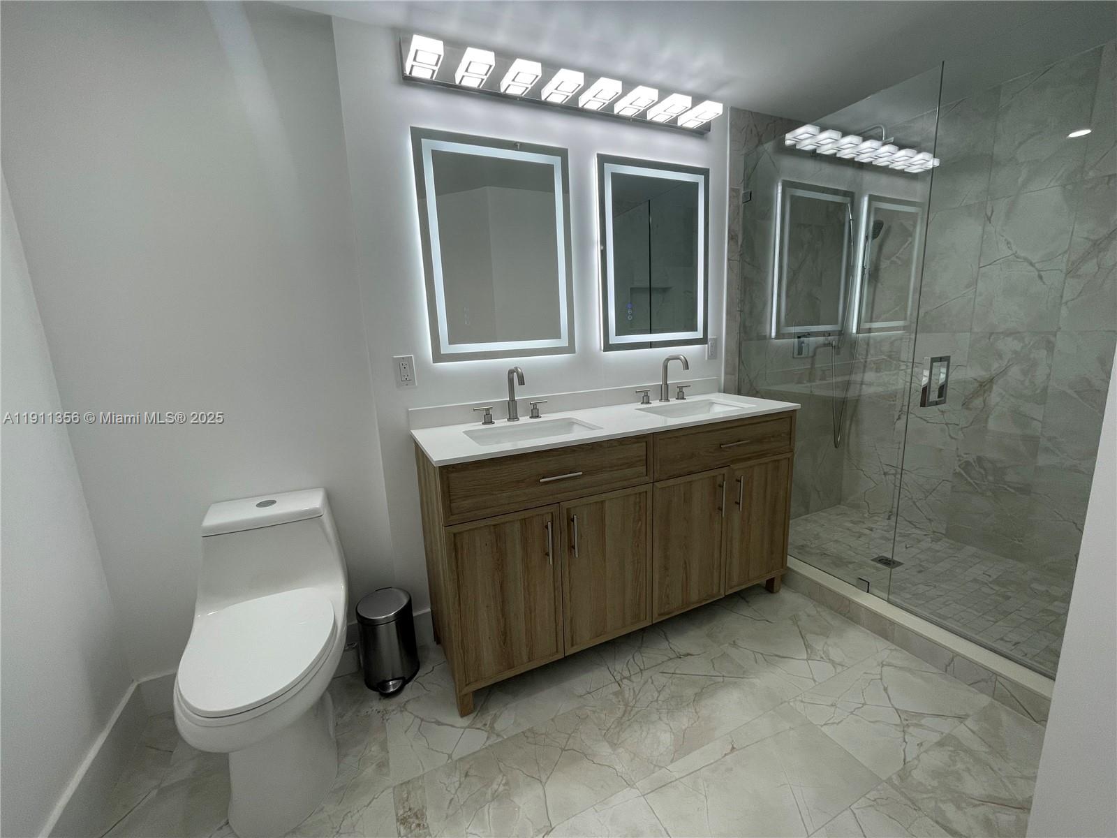 17100 North Bay Road, Unit 1118 Sunny Isles Beach, FL 33160 - Photo 28 of 34 a bathroom with a toilet sink and mirror
