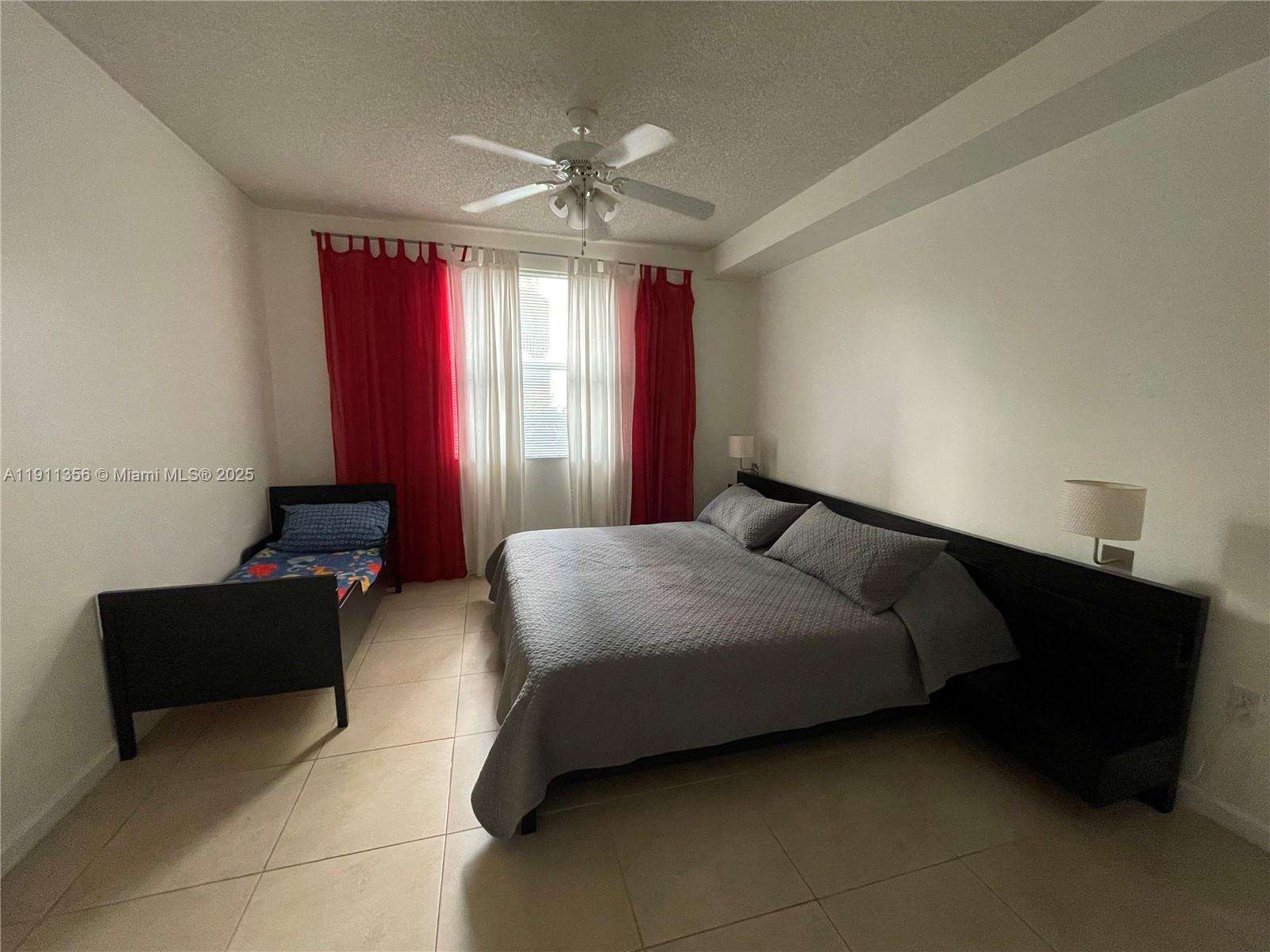 17100 North Bay Road, Unit 1118 Sunny Isles Beach, FL 33160 - Photo 29 of 34 a bedroom with bed and window