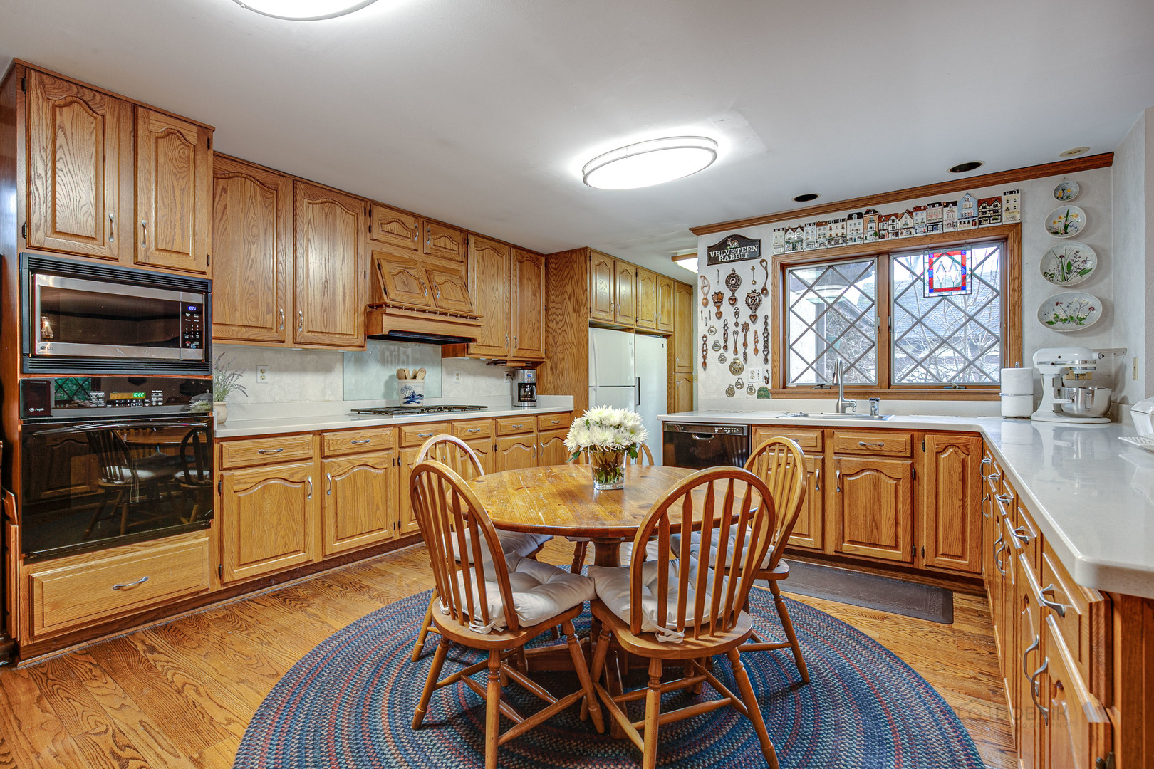 889 Willow Road Winnetka, IL 60093 - Photo 2 of 28 a kitchen with granite countertop wooden cabinets and stainless steel appliances