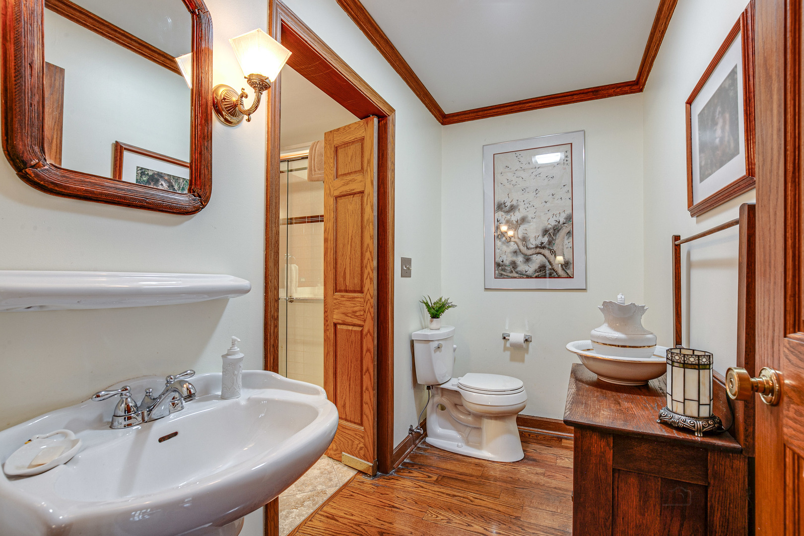 889 Willow Road Winnetka, IL 60093 - Photo 12 of 28 a bathroom with a sink a toilet and a mirror