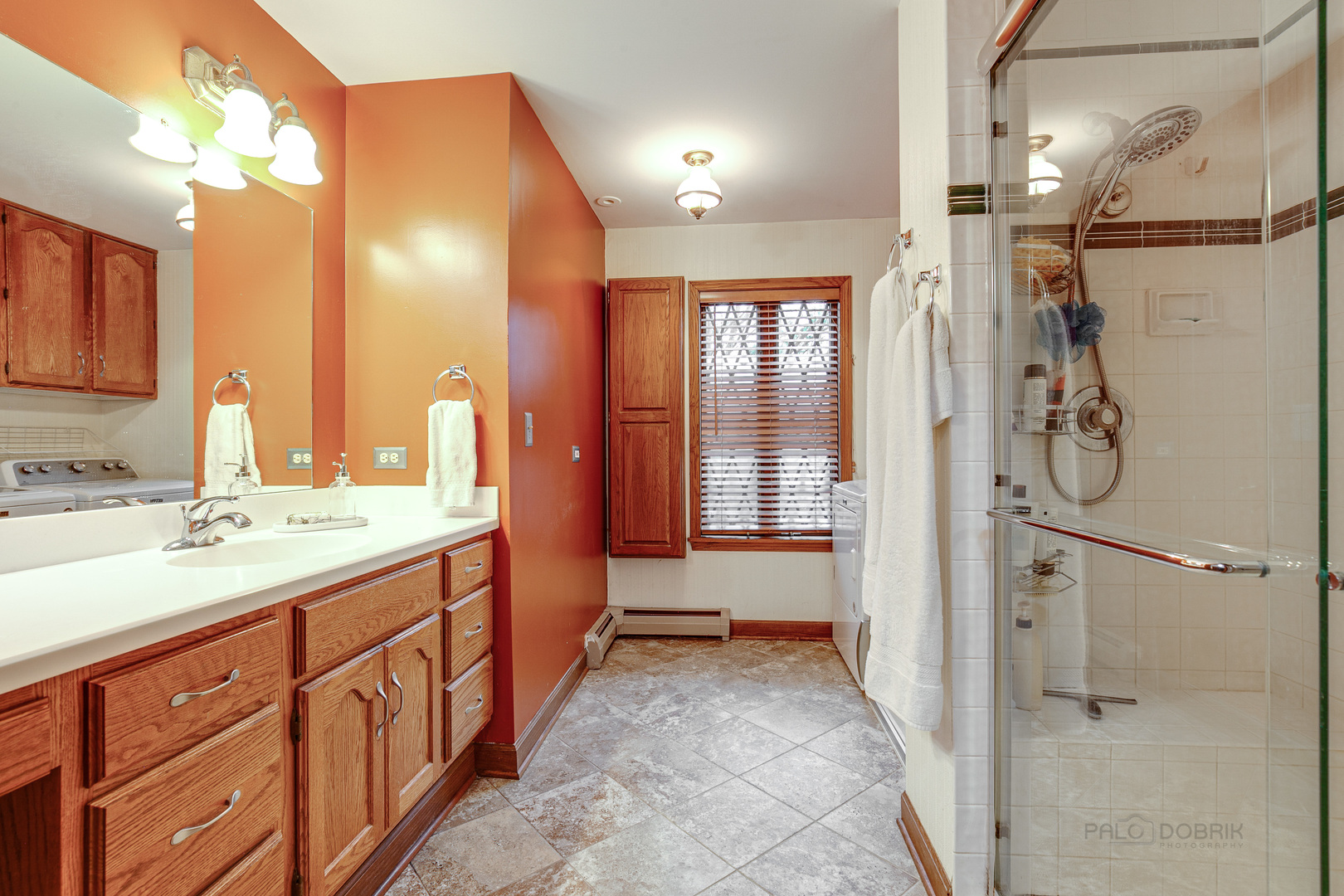 889 Willow Road Winnetka, IL 60093 - Photo 13 of 28 a bathroom with a double vanity sink toilet and shower