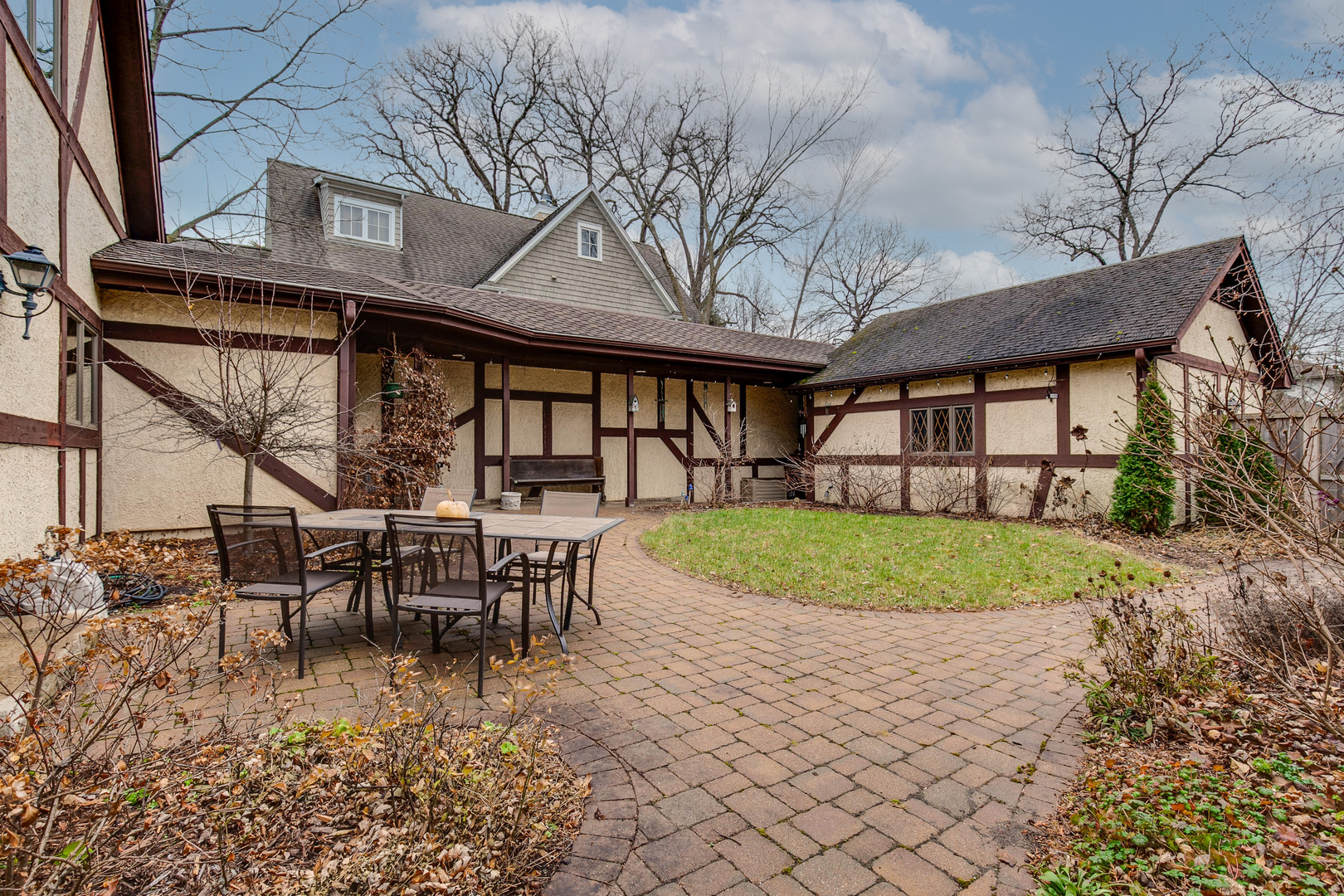 889 Willow Road Winnetka, IL 60093 - Photo 23 of 28 a front view of a house with garden and porch