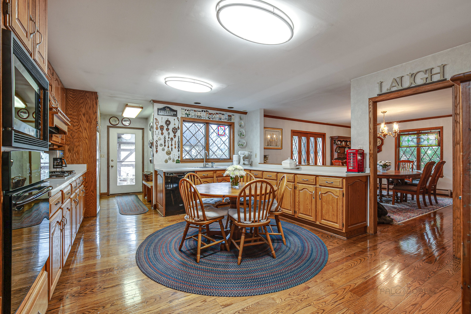 889 Willow Road Winnetka, IL 60093 - Photo 4 of 28 a view of a dining room with furniture a rug and wooden floor