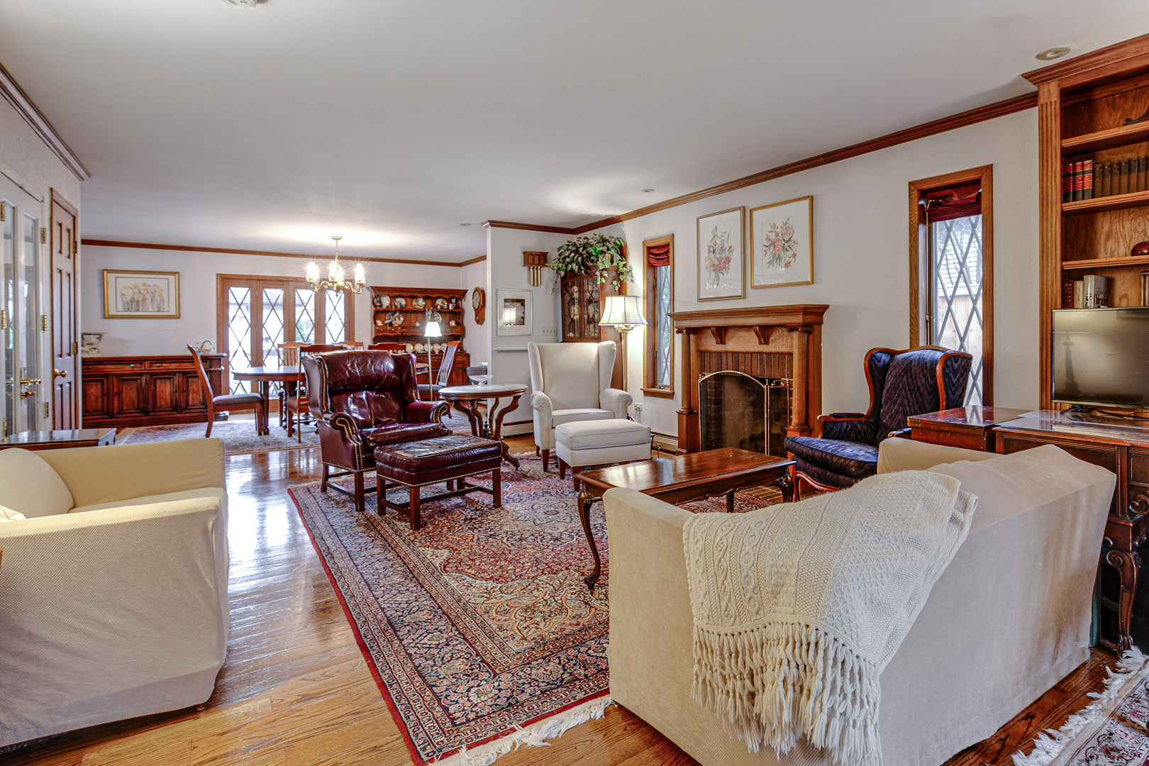 889 Willow Road Winnetka, IL 60093 - Photo 6 of 28 a living room with fireplace furniture and a flat screen tv