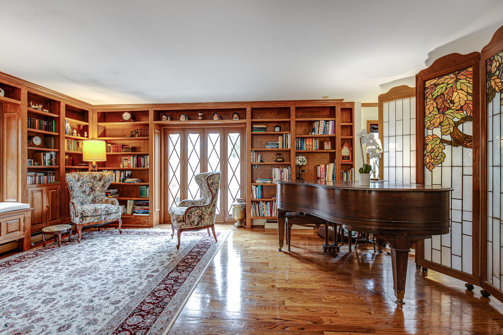 889 Willow Road Winnetka, IL 60093 - Photo 8 of 28 a living room with furniture a rug and wooden floor