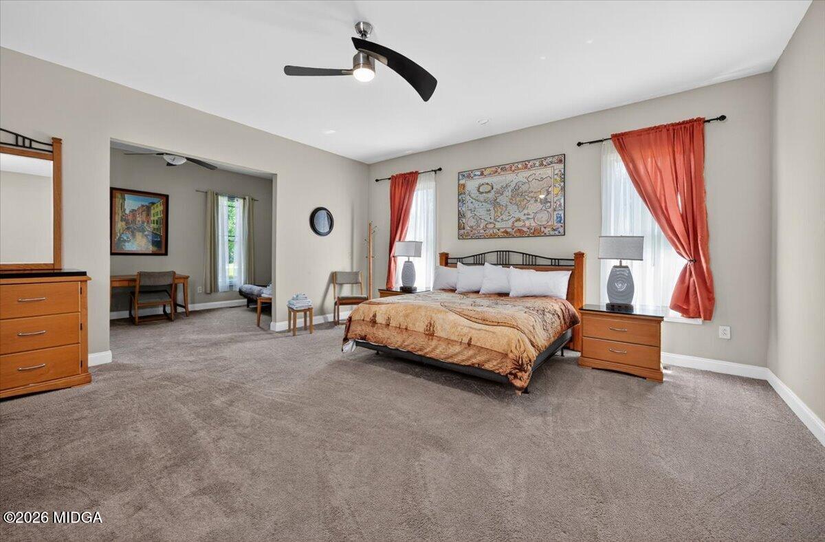 2415 Elko Road Elko, GA 31025 - Photo 21 of 57 a spacious bedroom with a large bed and a chandelier