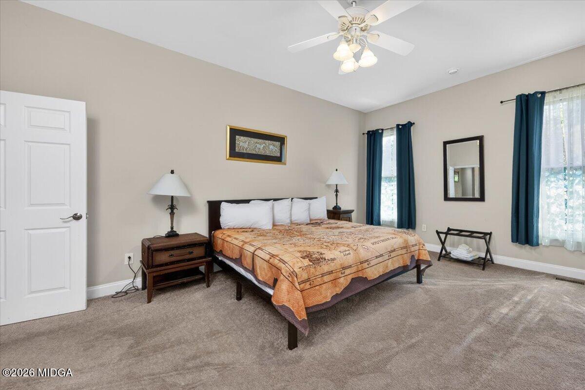 2415 Elko Road Elko, GA 31025 - Photo 29 of 57 a spacious bedroom with a bed and a chandelier