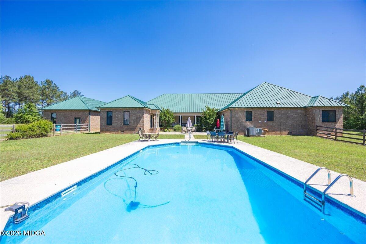 2415 Elko Road Elko, GA 31025 - Photo 3 of 57 a house with swimming pool in front of it