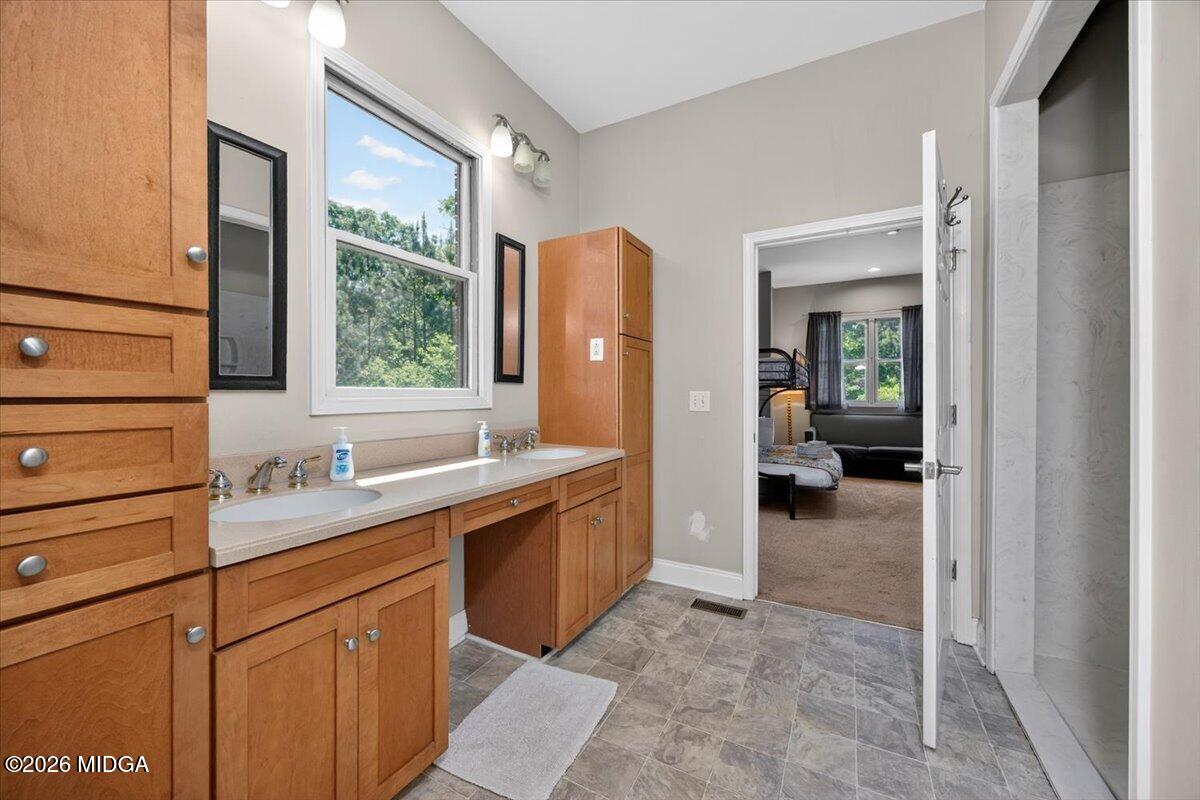2415 Elko Road Elko, GA 31025 - Photo 31 of 57 a spacious bathroom with a granite countertop sink mirror and a bathtub