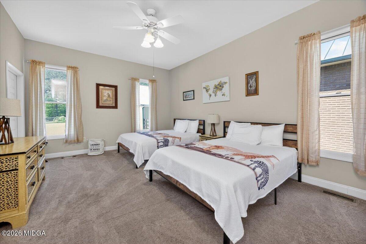 2415 Elko Road Elko, GA 31025 - Photo 40 of 57 a bed room with a bed and a chandelier