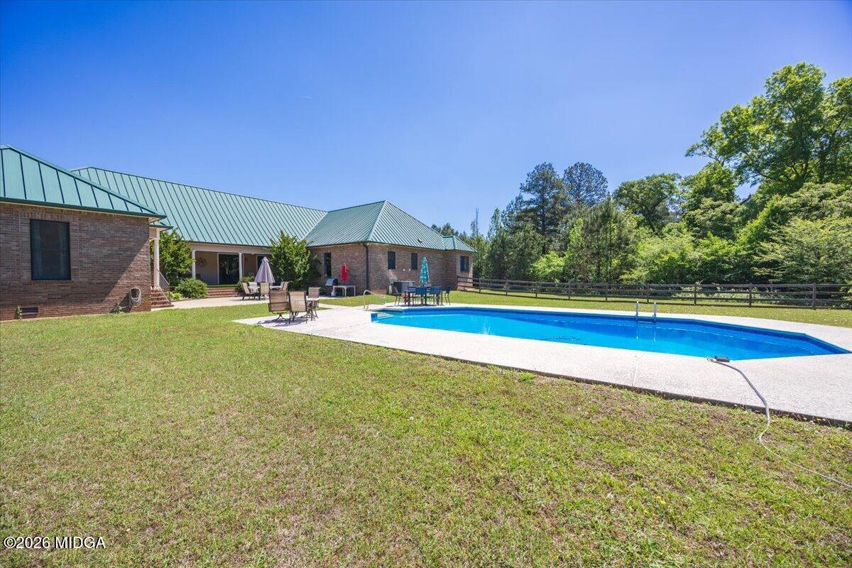 2415 Elko Road Elko, GA 31025 - Photo 49 of 57 a swimming pool with outdoor seating and yard