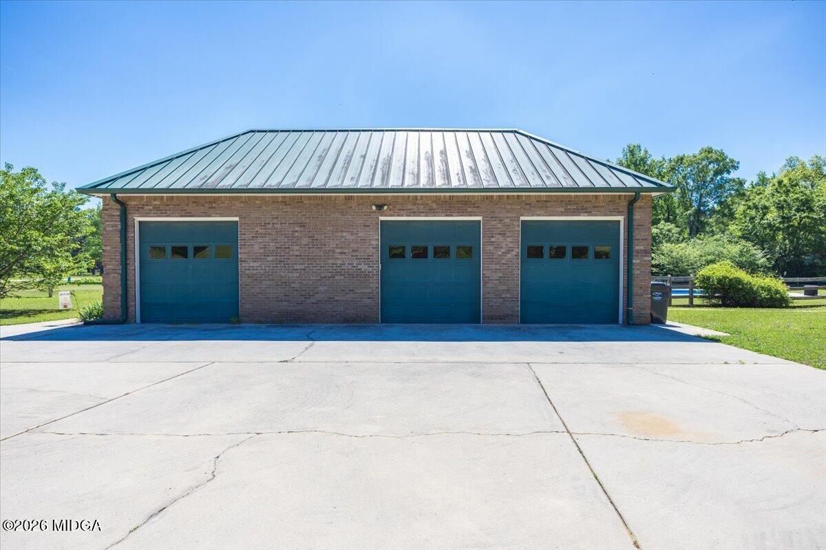2415 Elko Road Elko, GA 31025 - Photo 54 of 57 a front view of a house with a yard and garage