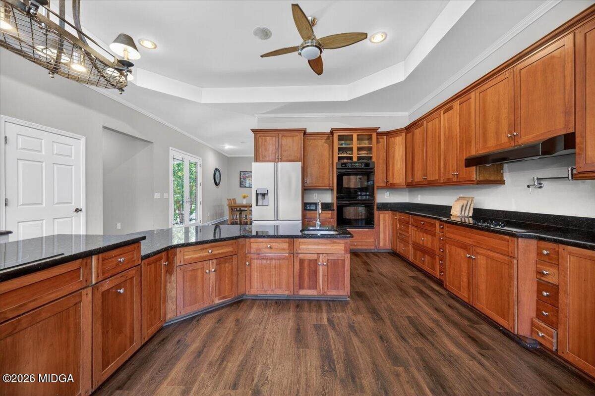 2415 Elko Road Elko, GA 31025 - Photo 10 of 57 a large kitchen with stainless steel appliances wooden floors large window a sink and cabinets
