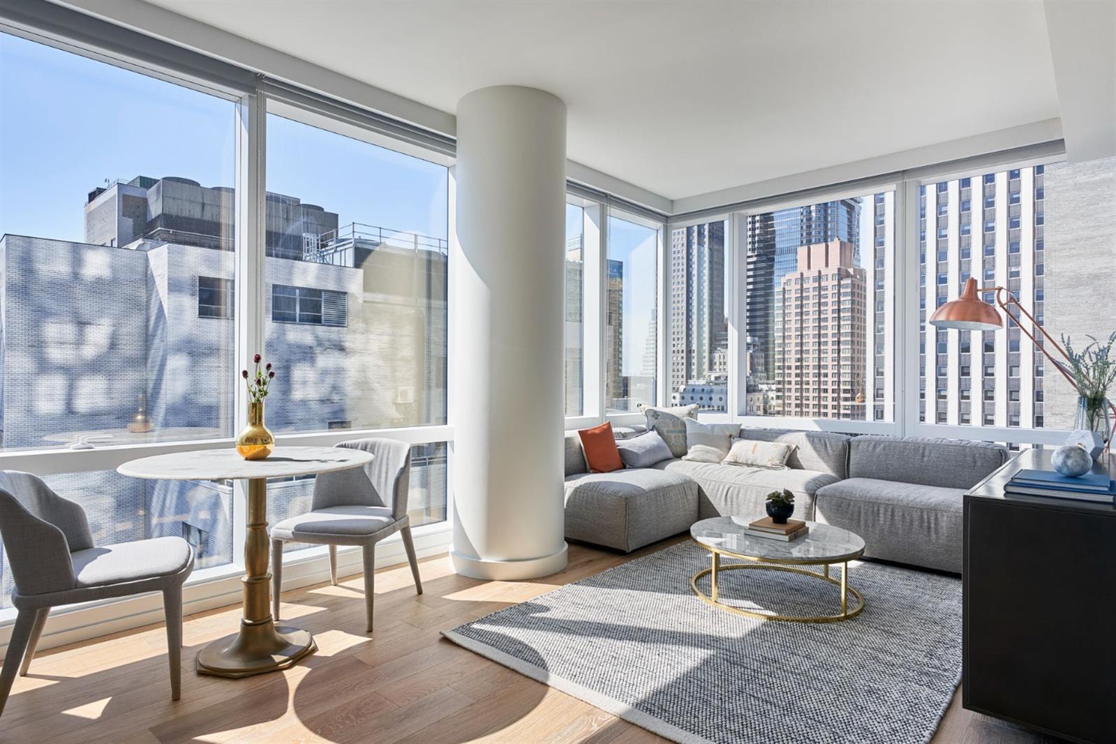 19 Dutch Street, Unit 50H Manhattan, NY 10038 - Photo 14 of 36 a living room with furniture and a large window