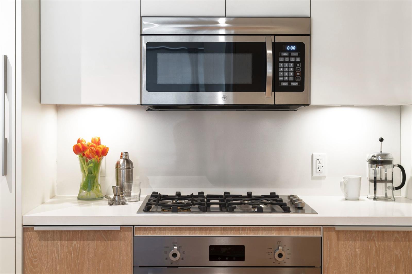 19 Dutch Street, Unit 50H Manhattan, NY 10038 - Photo 21 of 36 a stove top oven sitting inside of a kitchen
