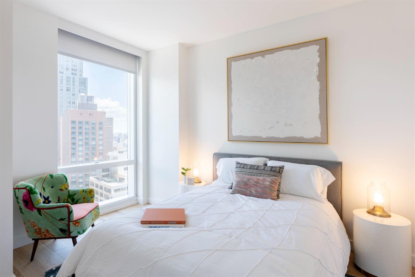 19 Dutch Street, Unit 50H Manhattan, NY 10038 - Photo 7 of 36 a bedroom with a bed and window