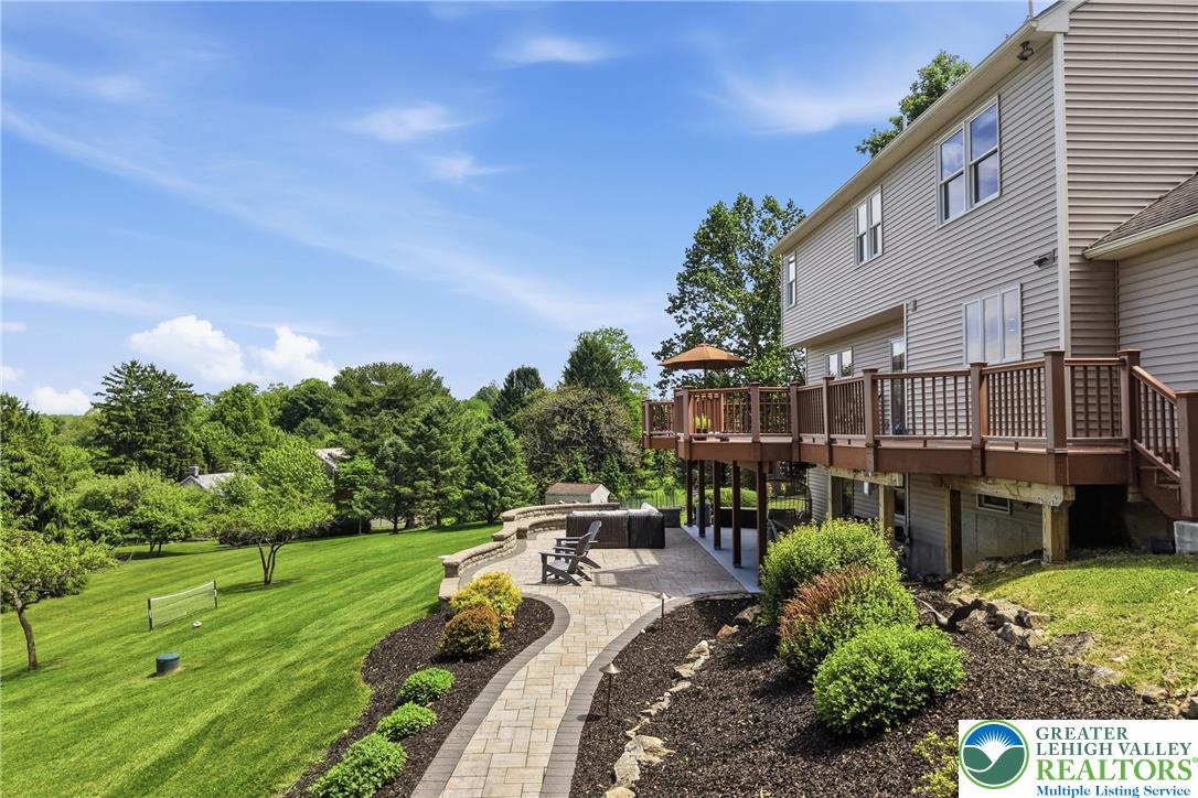 115 West Butternut Road Hellertown, PA 18055 - Photo 64 of 97 A spacious backyard unfolds, featuring a large deck, expansive lawn, and a charming patio retreat.