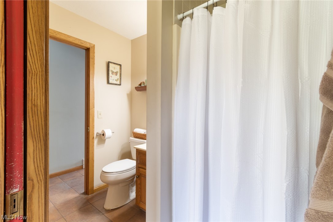 8089 Thomas Road Lisbon, OH 44432 - Photo 24 of 46 Bathroom featuring vanity, toilet, and tile flooring